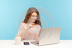 Small amount, low rating. Disappointed woman employee showing a little bit gesture to laptop screen, talking on video call