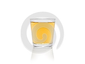 A small amount of whiskey in a glass goblet isolated on a white background