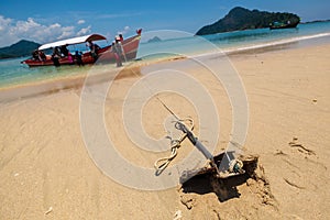 Small Anchor in Beach Sand for Parking Tourism Boat in the Island