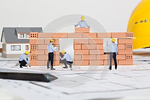 Small architects building model house construction