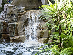 A small artificial waterfall feature in a modern luxury home setting