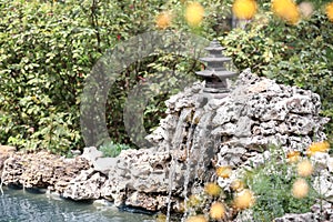 Small artificial waterfall in oriental garden