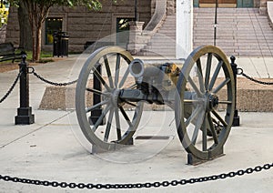 Small artillery canon at the front of the historic Tarrant County Courthouse in Fort Worth, Texas.