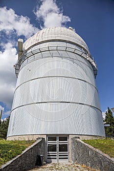 Small astronomical observatory with telescope in Bulgarian mountains at the sunset