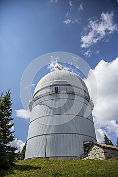 Small astronomical observatory with telescope in Bulgarian mountains at the sunset