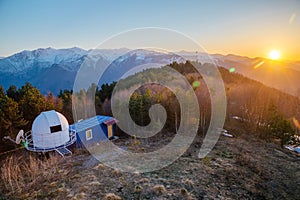 Small astronomical observatory with telescope in Caucasian mountains at the sunset