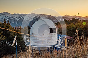 Small astronomical observatory with telescope in Caucasian mountains at the sunset