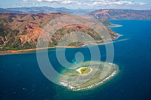 A small atoll islet with heart shaped coral reef off the east coast of Grande Terre island of New Caledonia, Melanesia, Oceania.