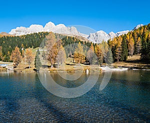 Small autumn alpine mountain pond not far from San Pellegrino Pass, Trentino, Dolomites Alps, Italy photo