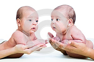 Small babies twins boys on parental hands