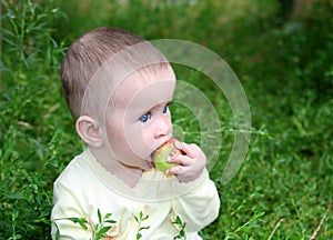 Small baby biting apple