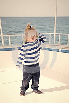 Small baby boy sailor, captain of yacht in marine shirt