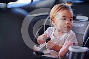 Small baby girl inside of car