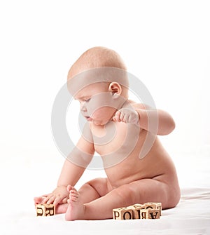 Small baby playing with blocks after taking a bath 2