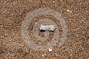 Small bag of snuff in the sand on a beach..