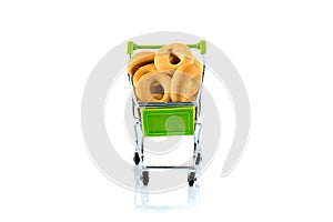 Small bagels in a metal shopping trolley isolated on white.