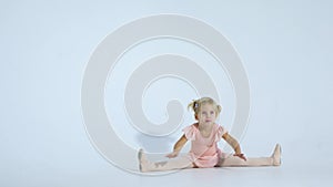 A small ballerina dances with enthusiasm. The girl is engaged in ballet