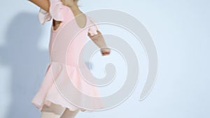 A small ballerina dances with enthusiasm. The girl is engaged in ballet