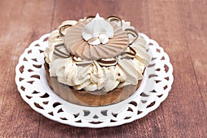 Small Banofee La Felicita tart with white meringue on brown background photo
