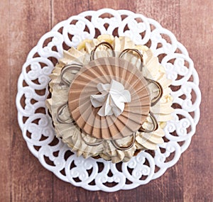 Small Banofee La Felicita tart with white meringue on brown background photo