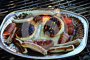 Small barbecue accident - cinder camembert cheese leaking to sausages and bratwursts on alluminum plate