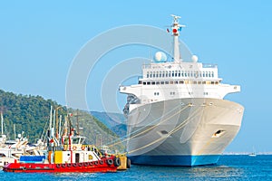 Small barge and a huge liner