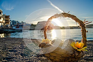 Small basket with two easter eggs on the sea doc on golden hour