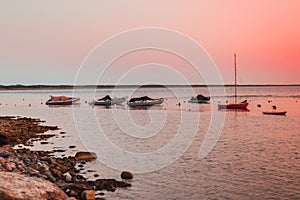 small bay with a beach and boats in the north of Sardinia.Beautiful sunset