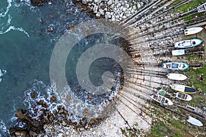 Small bay and pier with fishing boats on the shore