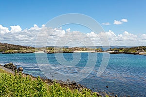 Small bay with rocks on the shoreline, sunny spring day photo