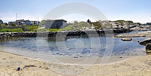 A small beach with children sand toys and clean water in Kvernevik suburb