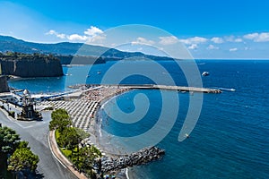 Small beach full of colorful sunbeds and umbrellas