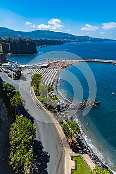 Small beach full of colorful sunbeds and umbrellas