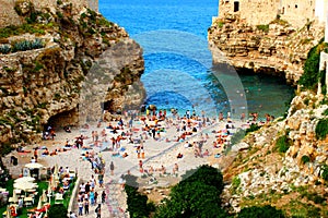 Small beach of Lama Monachile wedged between two rocky walls of Polignano a Mare coast
