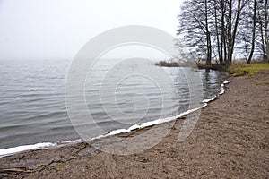 Small beach in late foggyautumn