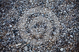 Small beach light pebble rocks floor. Different stones background texture in nature. Outdoors. Grid gravel with several shapes. Na