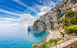 Small beach on rocky shore near Positano on Amalfi Coast in Campania, Italy