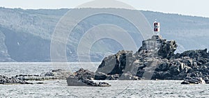 Small beacon lightstation on rocks in Bona Vista proper beach, Newfoundland.