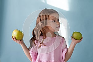 Small beautiful girl eating fresh fruit Green Apple