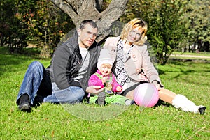 Small beautiful girl with parent on green glade