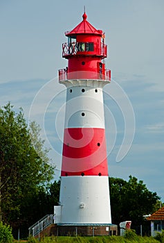 A small and beautiful lighthouse in daylight in FalshÃÂ¶ft, Germany photo