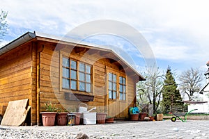 Small beautiful wooden house shed or storage hut for garden tools equipment and bicycles at backyard at beautiful