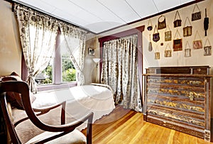 Small bedroom with hardwood floor and old sharpen furniture