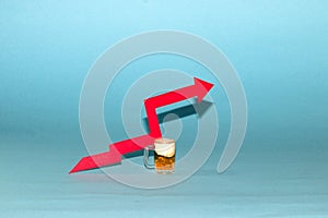 small beer and red arrow up, rising alcohol prices, pastel blue background