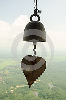 Small bell hanging under roof in temple