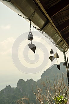 Small bell hanging under roof in temple