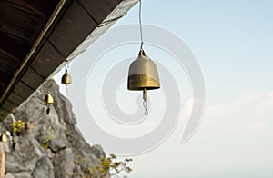 Small bell hanging under roof in temple