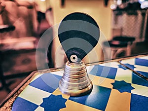 Small bell on a wooden table in traditional Chinese tea room