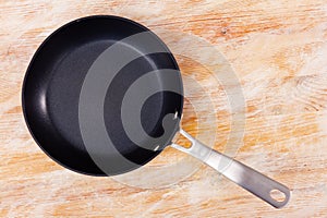 Small black enameled frying pan with long handle