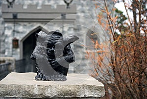 Small black gargoyle awaits unaware visitors